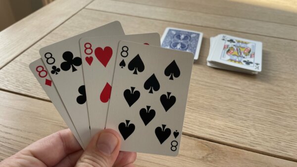 A player holding all of the 8's in a deck of cards