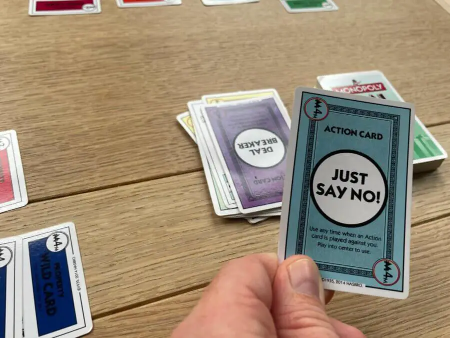 A player about to play the "Just Say No!" card in a game of Monopoly Deal