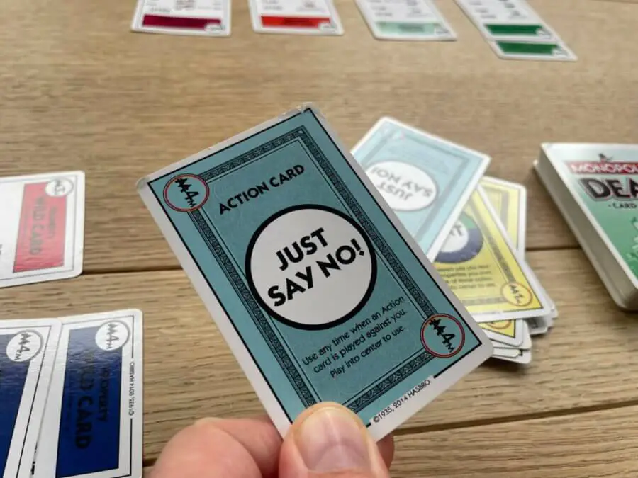 A player about to play the "Just Say No!" card to counteract another "Just Say No!" card in a game of Monopoly Deal