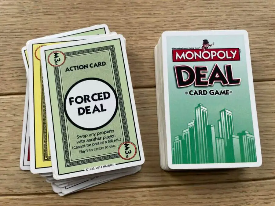 The "Forced Deal" card being actively played in a game of Monopoly Deal