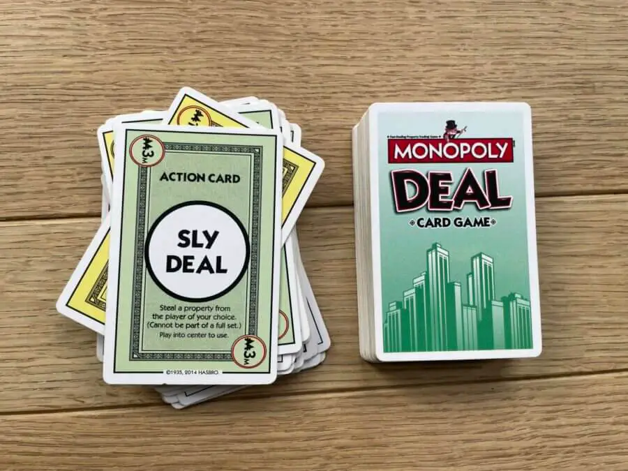 The "Sly Deal" card being actively played in a game of Monopoly Deal