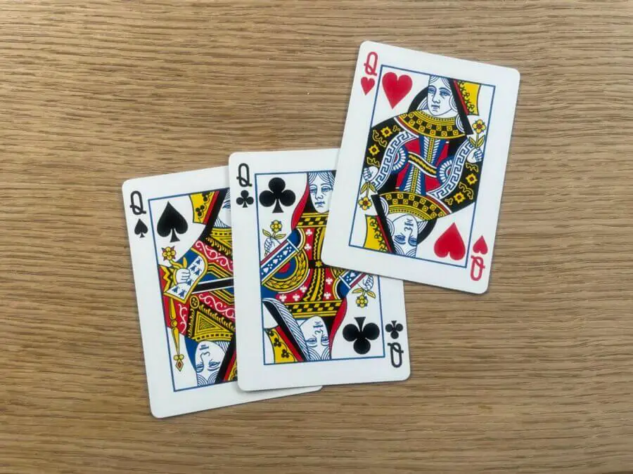 Removing the Queen of Diamonds and showing the Queen of Hearts unpaired (he "Old Maid")
