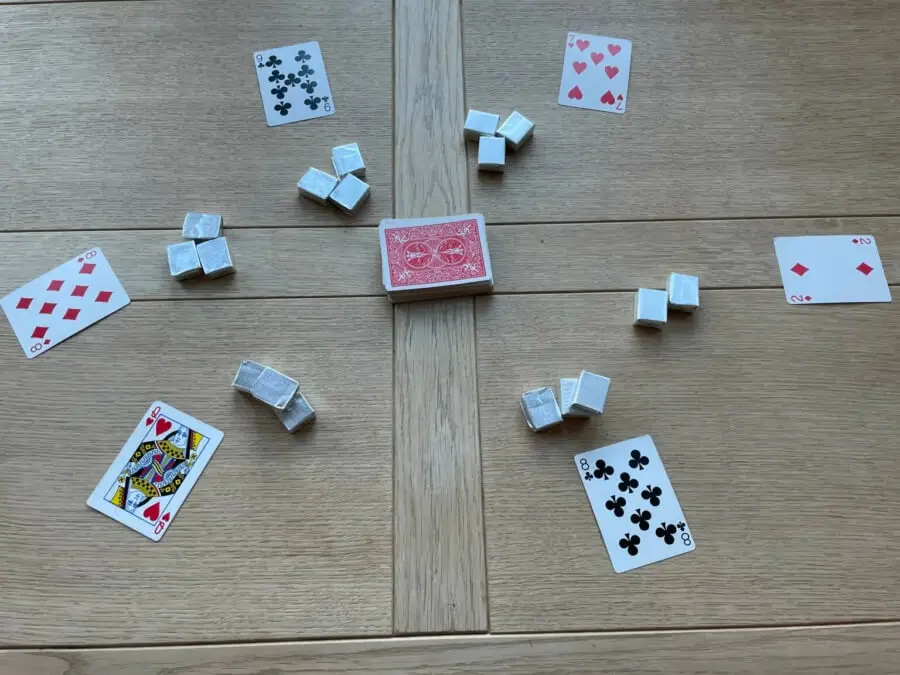 All 5 cards in a game of Chase The Ace are revealed, showing the player to the right loses the round with a 2 of Diamonds.