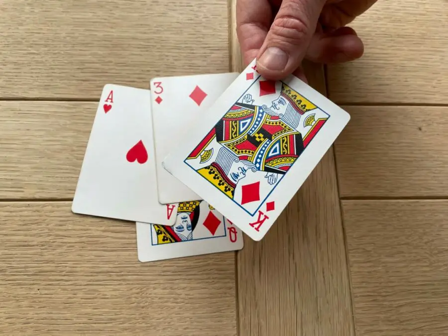 A hand in the game of Barbu, showing the last player losing the trick with a King of Diamonds.